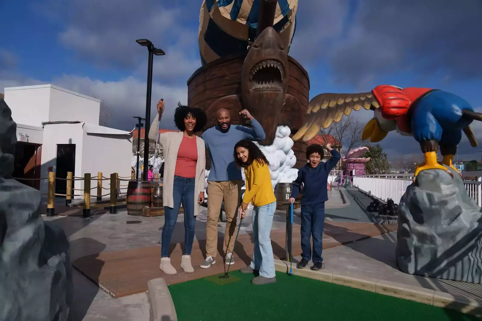 family playing mini golf on the rooftop course