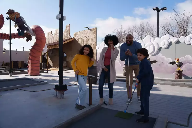 family playing mini golf