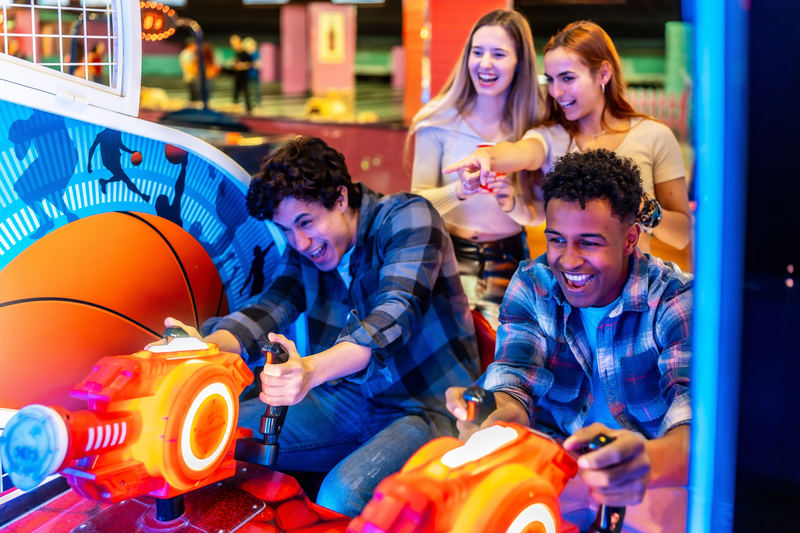 group of friends playing arcade games
