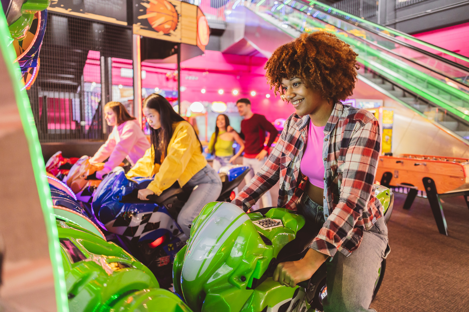 people playing racing games in arcade