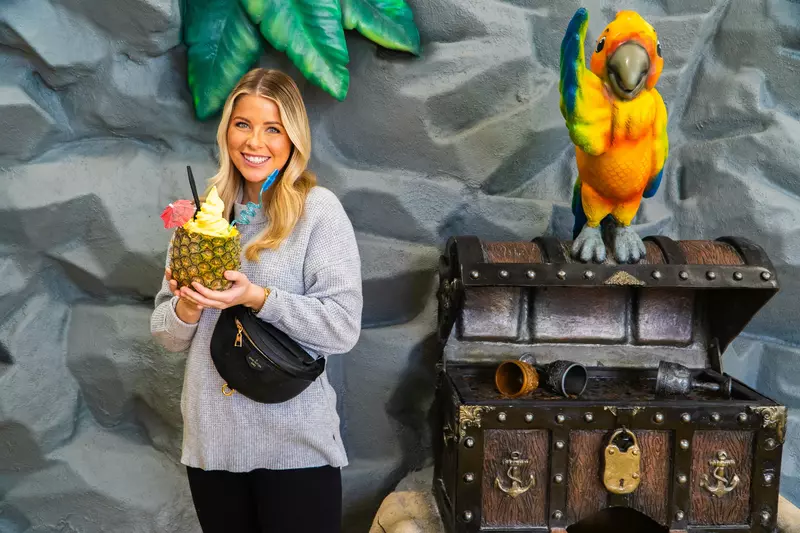 Girl holding dole whip float in pineapple