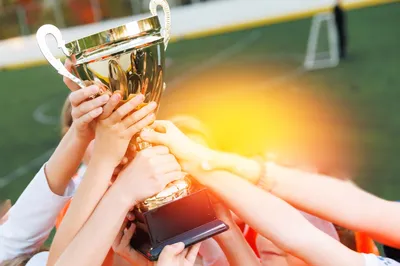 trophy being held by kids